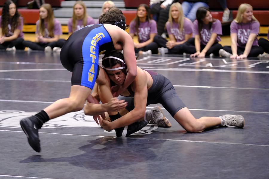 An Edmond wrestler battles for position on the mat