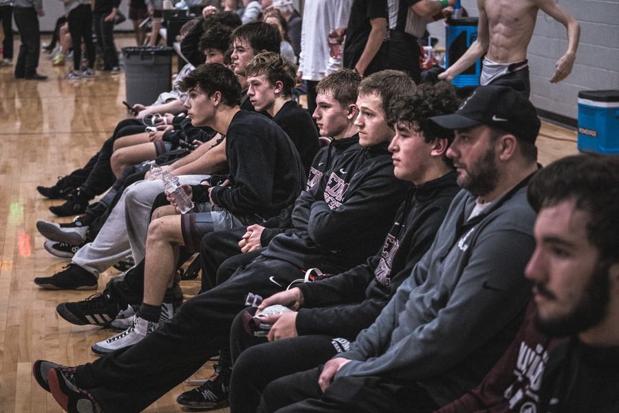 The Edmond bench watches a teammate compete